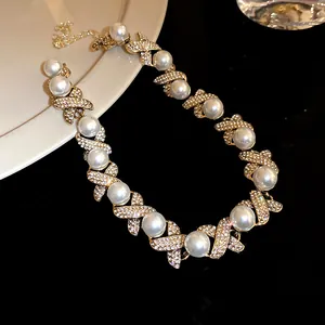 Detailed view of French vintage palace style pearl necklace with rhinestone X-links