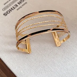 Macro view of golden multi-layer cuff bracelet with chic leopard print leather inlay