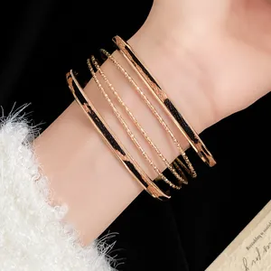 Detailed macro view of a stylish gold cuff bracelet set featuring leopard print leather inserts