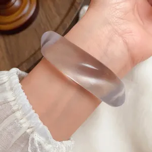 Minimalist acrylic irregular marbled bangle with vintage aesthetic shown on a wrist