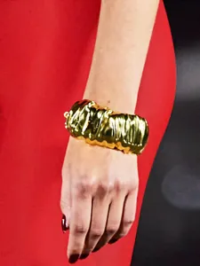 Detailed macro shot of a minimalist irregular gold wrinkled wide cuff bracelet for women.
