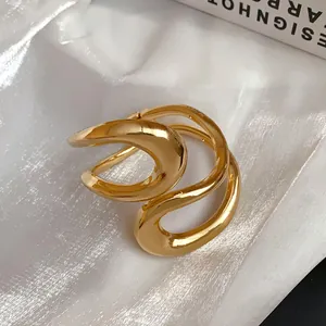 Detailed view of polished gold irregular geometric open cuff bracelet