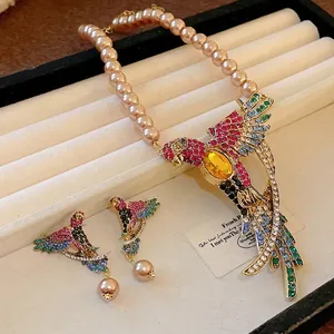 Vintage bird pendant necklace and earring set with colorful rhinestones and pearls.