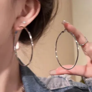 Minimalist large silver hoop earrings for women, simple aesthetic style.