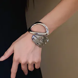 Detailed shot of a silver chunky irregular geometric hollow cross open cuff bracelet
