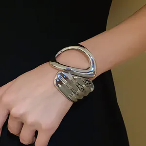 Detailed view of irregular geometric hollow cross open bracelet in polished silver
