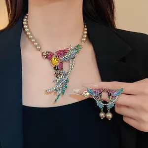 Close-up detail of a vintage court style colorful rhinestone bird pendant with pearls.