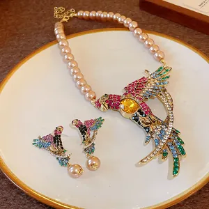 Vintage bird necklace set with colorful rhinestones and faux pearls in palace style.