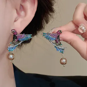 Vintage-style bird drop earrings with sparkling colorful rhinestones and faux pearl details.