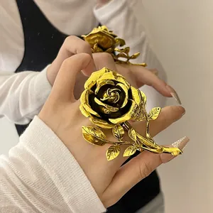 Detailed macro shot showing the intricate golden petals and stem of a vintage rose ring
