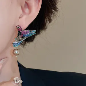 Elegant detail of vintage bird wing earring with rhinestones and pearl on model's ear