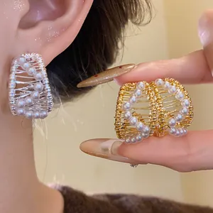 Elegant gold and silver wire-wrapped hoop earrings with delicate pearl embellishments