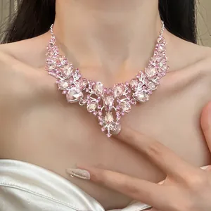 Close-up of elegant vintage-style pink rhinestone teardrop necklace worn on model