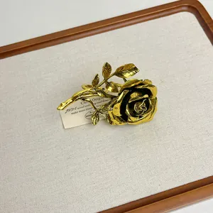 Detailed macro view of an elegant vintage golden rose ring on a textured display board