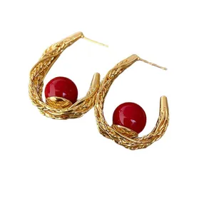 Vintage gold braided hoop earrings with vibrant red bead accent