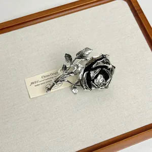 Macro view showing intricate details of vintage silver rose ring with antiqued finish