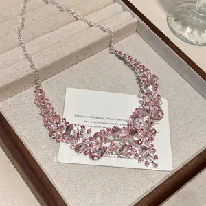 Detailed macro view of vintage pink teardrop rhinestone necklace with silver chain