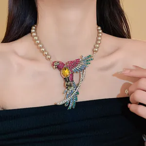 Detailed view of vintage bird necklace with colorful rhinestones and pearls on model.