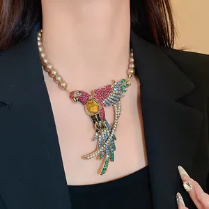 Close-up of a vintage parrot pendant necklace with colorful rhinestones and pearls