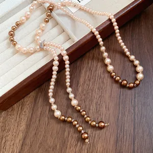 Detailed view of long pearl tassel necklace with sparkling rhinestone crystal accents