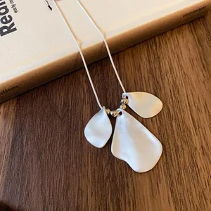 Minimalist irregular pleated petal necklace with matte white finish and silver beads