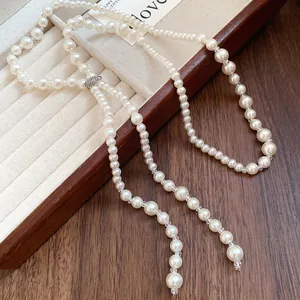 Detail view of high-end long pearl tassel necklace featuring sparkling rhinestone accents