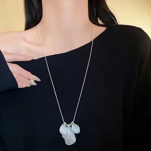 Minimalist irregular folded petal pendant necklace with matte silver finish for women.