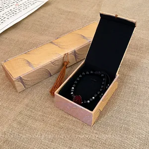 Elegant golden pattern jewelry gift box with tassel for bracelet and necklace display