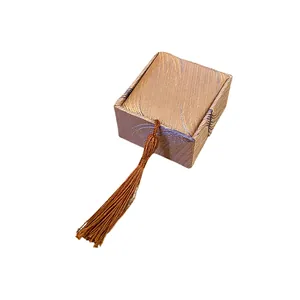 Elegant champagne fabric jewelry gift box with feather pattern and tassel detail