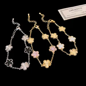 Detailed view of elegant gold-plated bracelets featuring multicolored flower charms