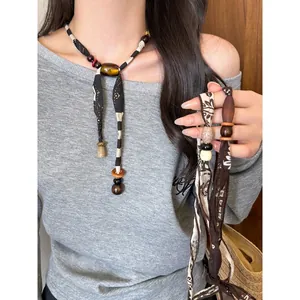 Bohemian ethnic style fabric necklace featuring wooden beads for a retro fashion look