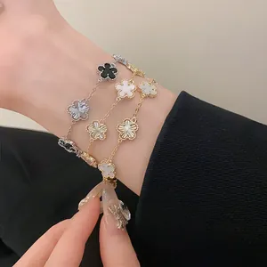 Detailed close-up showing multiple gold and silver plated four-leaf clover bracelets.