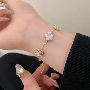 Detailed close-up view of a gold plated flower bracelet featuring elegant pink mother of pearl