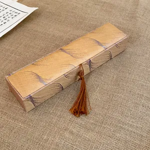 Detailed view of silk jewelry gift box featuring a woven feather pattern and tassel