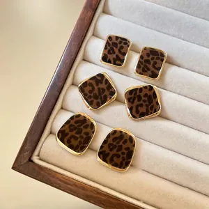 Vintage leopard print flocked earrings with geometric gold-tone frames for retro style