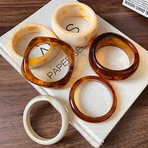 Elegant set of retro irregular resin bangles with tortoise shell and cream marble designs