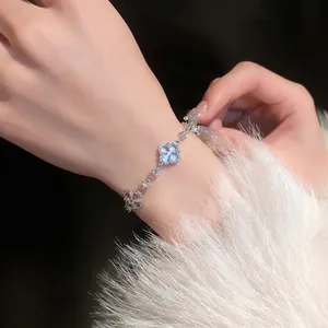 Elegant silver flower bracelet with sparkling zircon stones worn on female wrist for fashion
