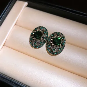 Elegant vintage oval green crystal stud earrings with pavé rhinestones in antique gold