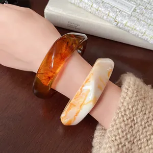 Macro view of retro irregular resin bangles with amber and marbled textures
