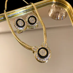 Nahaufnahme eines Vintage-Schmucksets mit schwarzer Emaille und Kristallen in Goldoptik