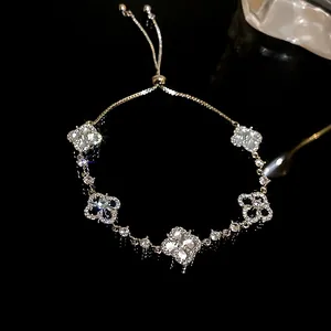 Macro view of zircon four-leaf clover bracelet with adjustable drawstring closure