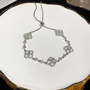 Close-up detail of silver zircon flower bracelet with adjustable bolo closure