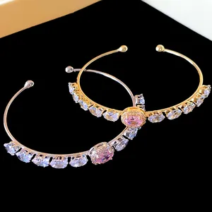 Detailed view of luxury pink oval zircon open bangles in gold and silver finish.