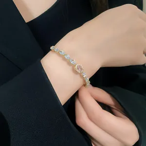 Close-up shot of sparkling oval zircon bracelet with pink gemstone on a female wrist