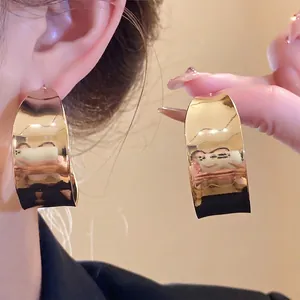 Elegant vintage gold C-shaped smooth hoop earrings with a minimalist fashion style