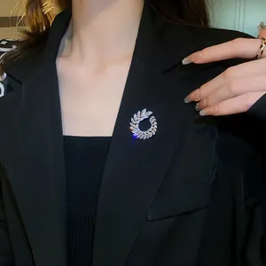 Close-up of elegant marquise zircon wreath brooch worn on a black blazer lapel