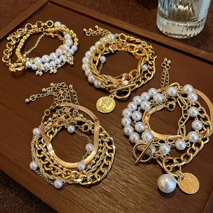 Vue détaillée de bracelets rétro dorés multicouches avec perles et breloques dorées