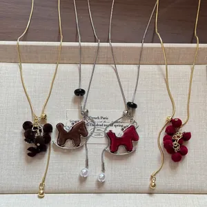 Elegant close-up of four flocked pendant necklaces arranged neatly in a gift tray