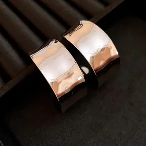 Macro detail of vintage-style silver C-shaped hoop earrings with a polished mirror finish.