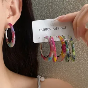 Detailed view of vibrant acetate marbled leopard print hoop earrings in multiple colors